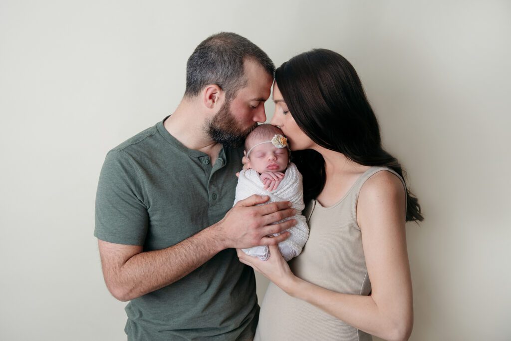 New parents kiss baby girl | Palatine baby photographer