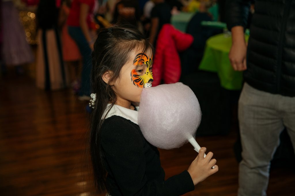 girl eating cotton candy at party at Galelry 611 in East Dundee