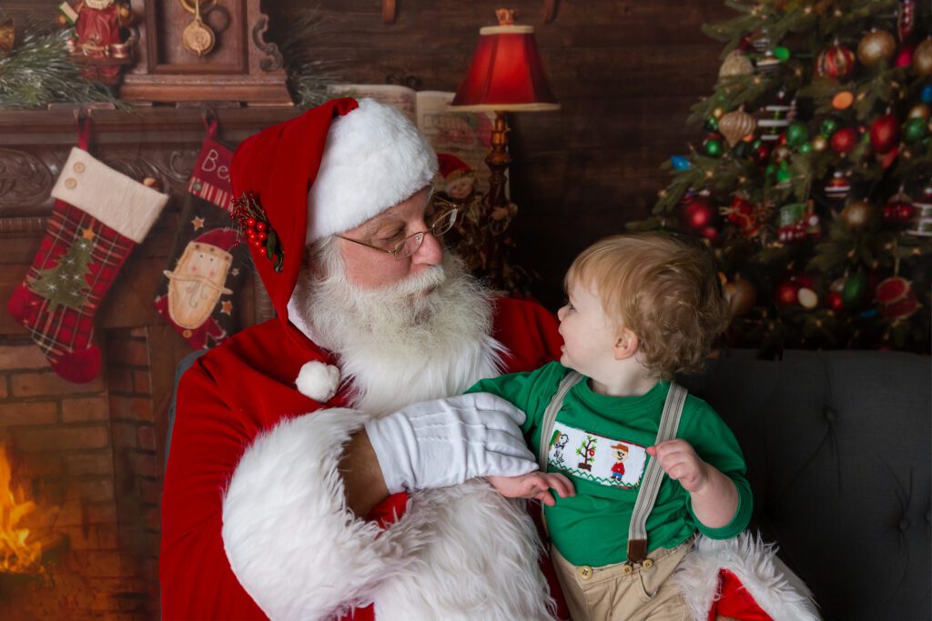 Sweet baby interacts with Santa at Just Peachy Photography in Palatine, IL
