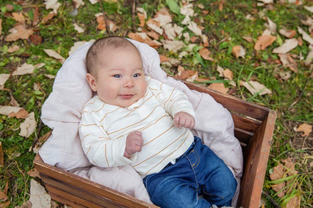 baby in fall leaves in Palatine IL for fall family mini sessions event by Just Peachy Photography
