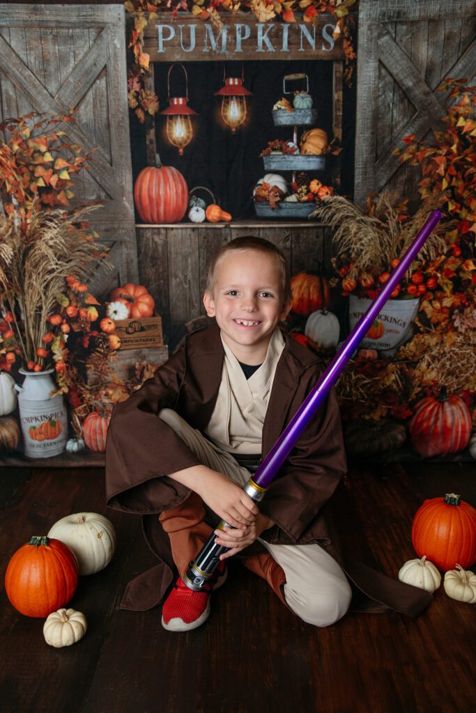 Boy in Jedi costume at Palatine Halloween event at Just Peachy Photography studio