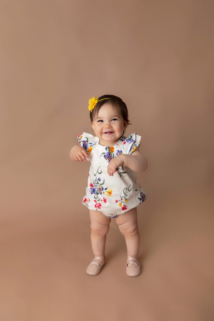 baby girl walking at one year old at Just Peachy Photography Baby Portrait Studio in Palatine IL | baby milestone portraits
