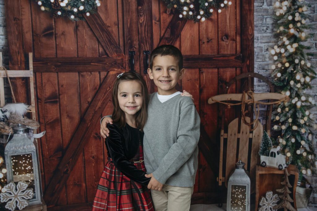 close sibling pose in studio holiday family photo session with Just Peachy Photography in Palatine, IL 