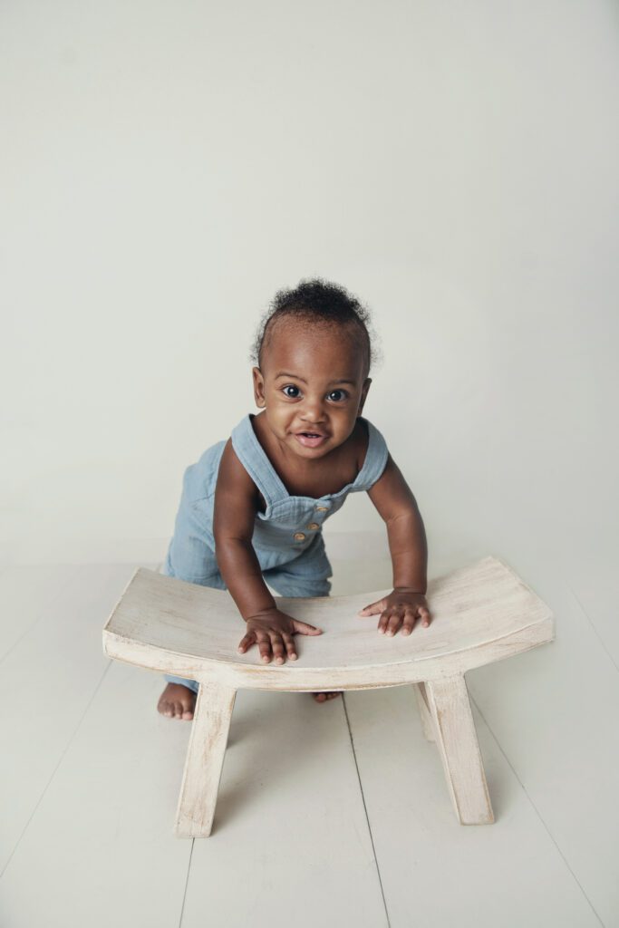baby boy standing with stool prop at Just Peachy Photography Baby Portrait Studio in Palatine IL | baby milestone portraits