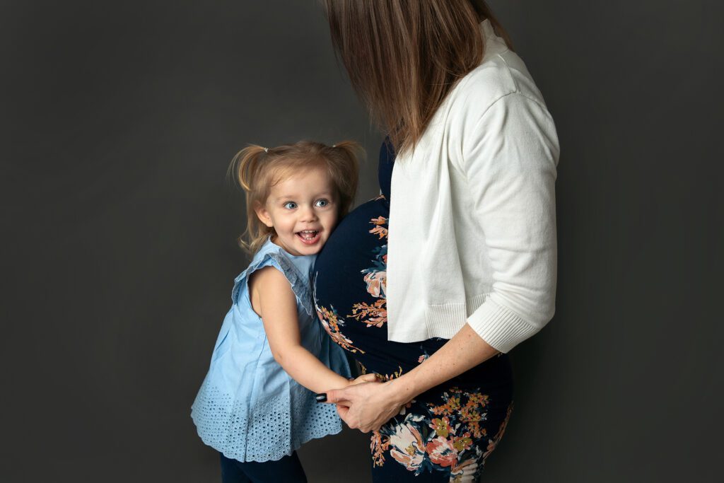 maternity studio portrait with toddler | Expecting Mom's belly and todder girl | Photographer Just Peachy Photography Palatine, IL